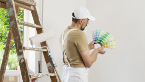 a professional painting contractor examining color swatches against a wall
